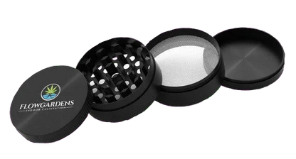 FlowGardens branded four-piece black herb grinder with mesh screen and logo lid