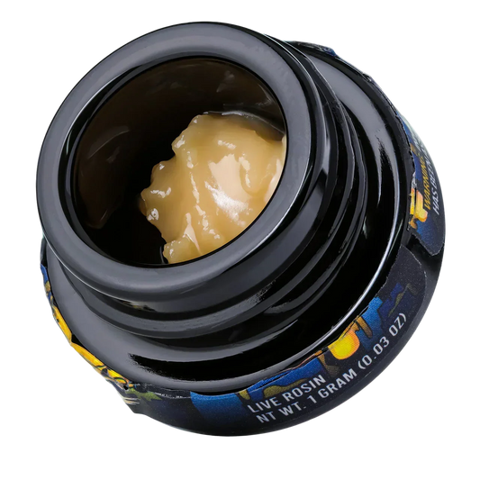 Black jar of live hash rosin concentrate, 1 gram, creamy yellow color, close-up